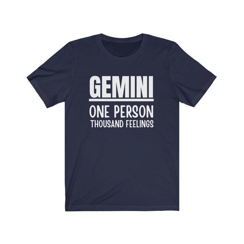 May include: A navy blue t-shirt with white text that reads "GEMINI ONE PERSON THOUSAND FEELINGS".