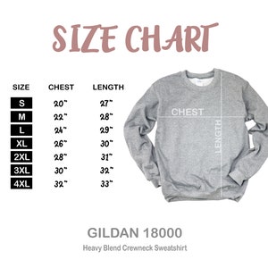 May include: A size chart for a Gildan 18000 heavy blend crewneck sweatshirt. The chart shows chest and length measurements in inches for sizes S through 4XL. The sweatshirt is light gray.