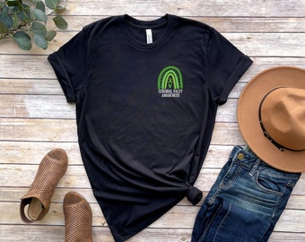 May include: Black t-shirt with a green rainbow and the text "Cerebral Palsy Awareness" on the front pocket.