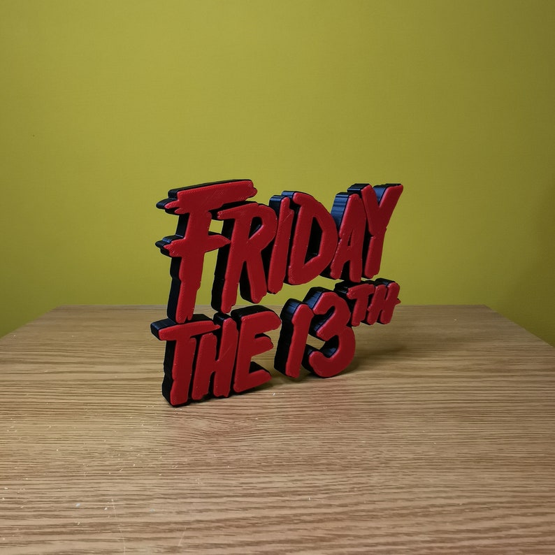 May include: A 3D printed red and black sign that reads "Friday the 13th".