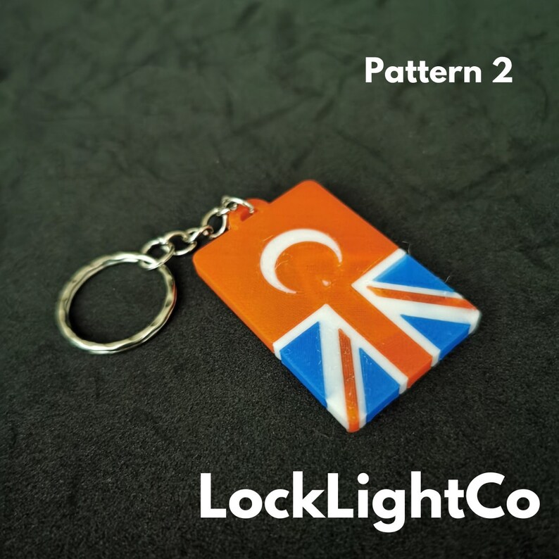 May include: Orange and blue keychain with a crescent moon and a Union Jack pattern. The keychain is labeled "LockLightCo" and "Pattern 2".