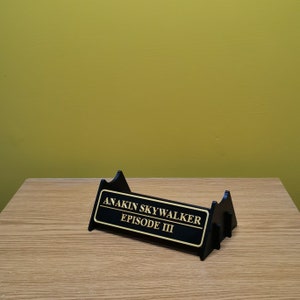 May include: Black display stand with a gold plaque that reads "Anakin Skywalker Episode III".
