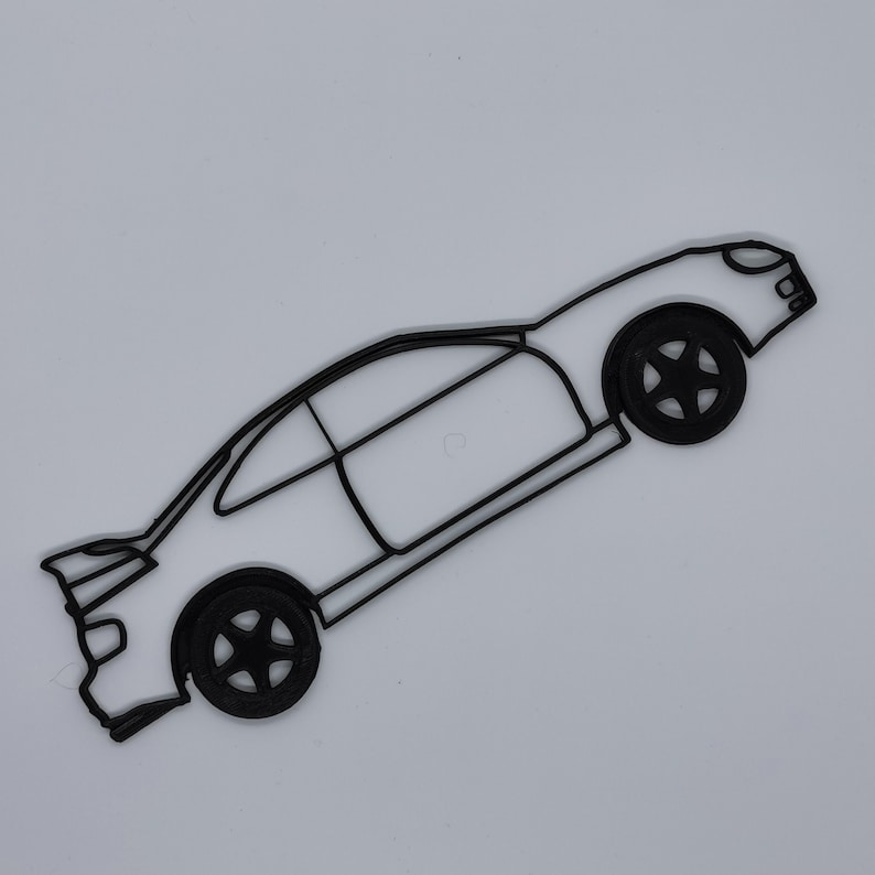 May include: A black line drawing of a car with a side profile view. The car has a rounded body style and large wheels. The car is drawn in a simple, minimalist style.
