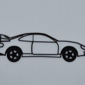 May include: A black line drawing of a coupe car with a rear spoiler. The car is facing to the right and has a simple design.