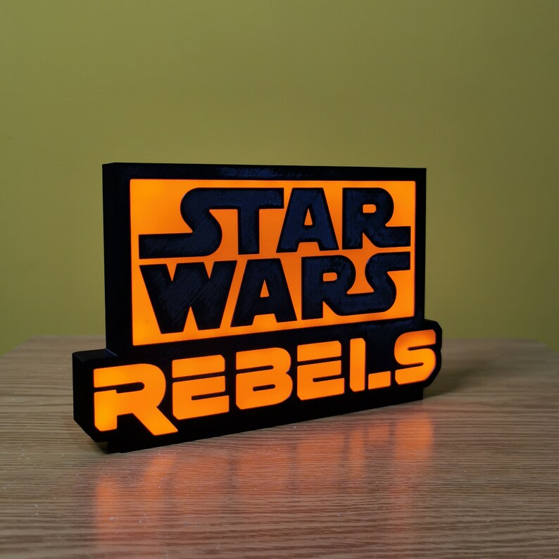May include: Black and orange light-up sign with the text "Star Wars Rebels".