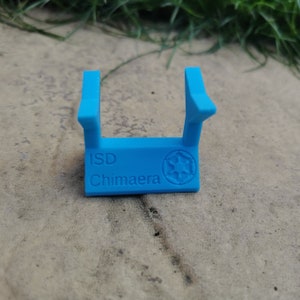 May include: A blue plastic stand with the text "ISD Chimaera" and a star wars symbol.