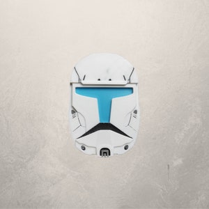 May include: A white plastic helmet with a blue visor. The helmet has a detailed design with black accents.
