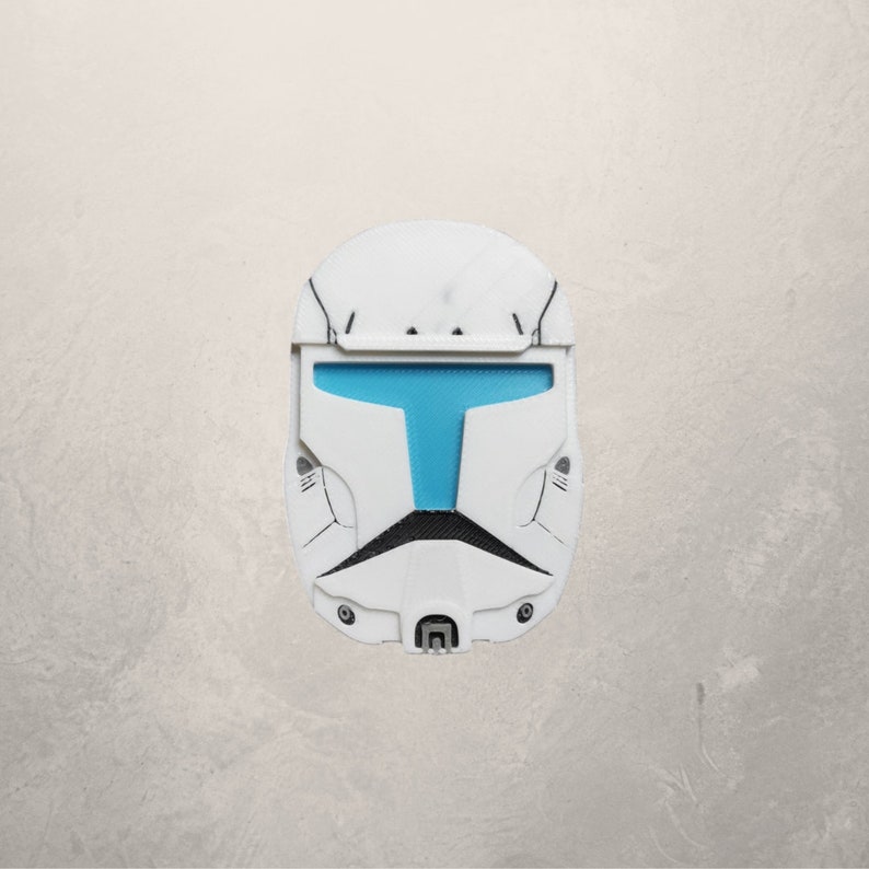 May include: A white plastic helmet with a blue visor. The helmet has a detailed design with black accents.