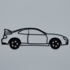 May include: A black line drawing of a sports car with a spoiler on the back. The car is facing to the right and has a side view.