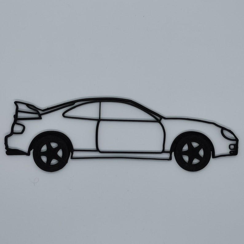 May include: A black line drawing of a sports car with a spoiler on the back. The car is facing to the right and has a side view.