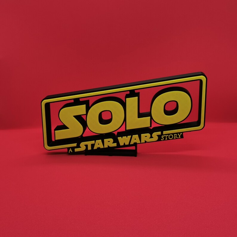 May include: A black and yellow sign with the text "SOLO: A STAR WARS STORY".