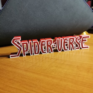 May include: A red and white 3D printed sign that reads "SPIDER-VERSE".