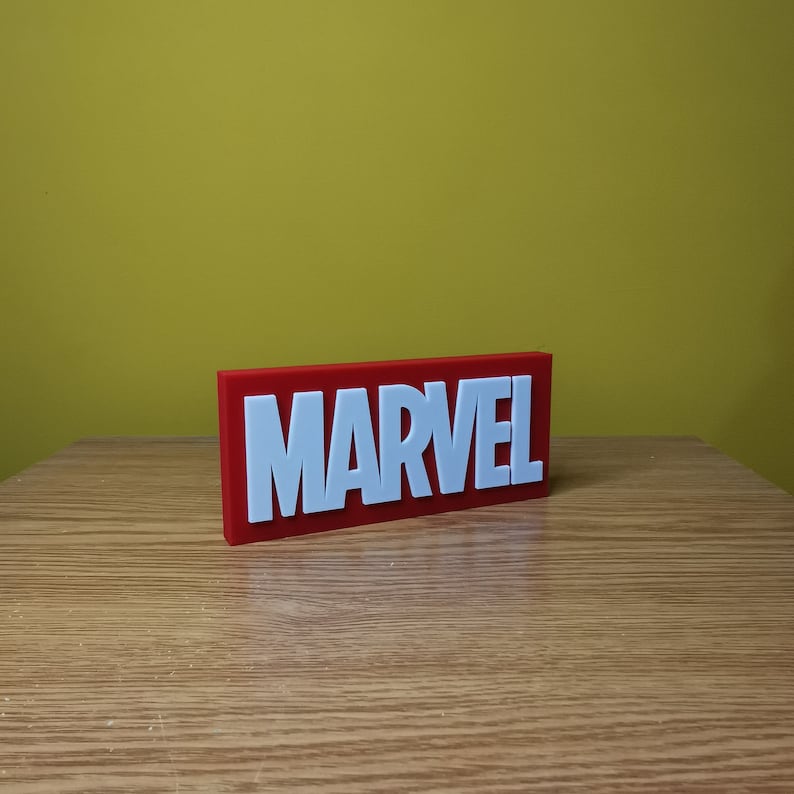 May include: A red rectangular block with the word "MARVEL" in white raised letters.