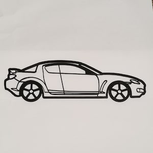 May include: A black and white line drawing of a sports car. The car is viewed from the side and has a sleek, modern design.