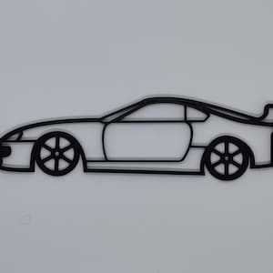 May include: Black line art silhouette of a sports car, a coupe, with a spoiler on the back. The car is facing to the right and is drawn in profile.