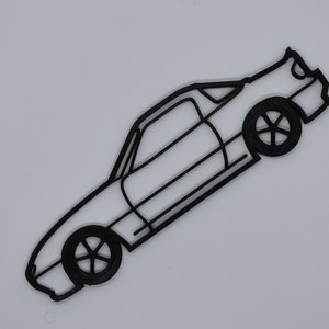 May include: A black line drawing of a sports car with a rounded roof and a spoiler. The car is facing to the right and is angled slightly upwards. The car has two doors and four wheels.