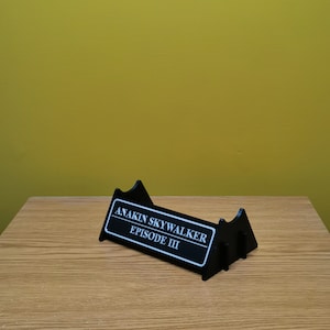 May include: Black plastic display stand with a white label that reads "ANAKIN SKYWALKER EPISODE III".