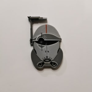 May include: A gray and white 3D printed helmet with a red stripe and a black visor. The helmet has a small antenna on top.
