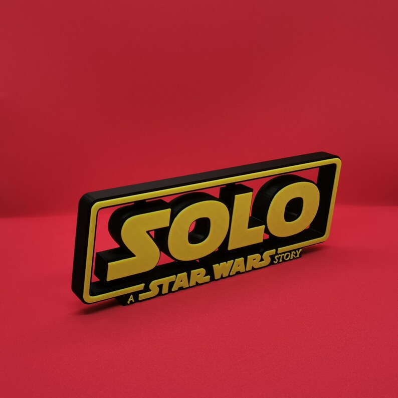 May include: A black and yellow 3D sign with the text "SOLO: A STAR WARS STORY".