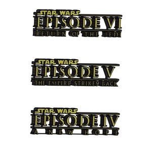 May include: Three Star Wars movie title cards with black backgrounds and gold text. The top card reads "STAR WARS EPISODE VI RETURN OF THE JEDI". The middle card reads "STAR WARS EPISODE V THE EMPIRE STRIKES BACK". The bottom card reads "STAR WARS EPISODE IV A NEW HOPE".