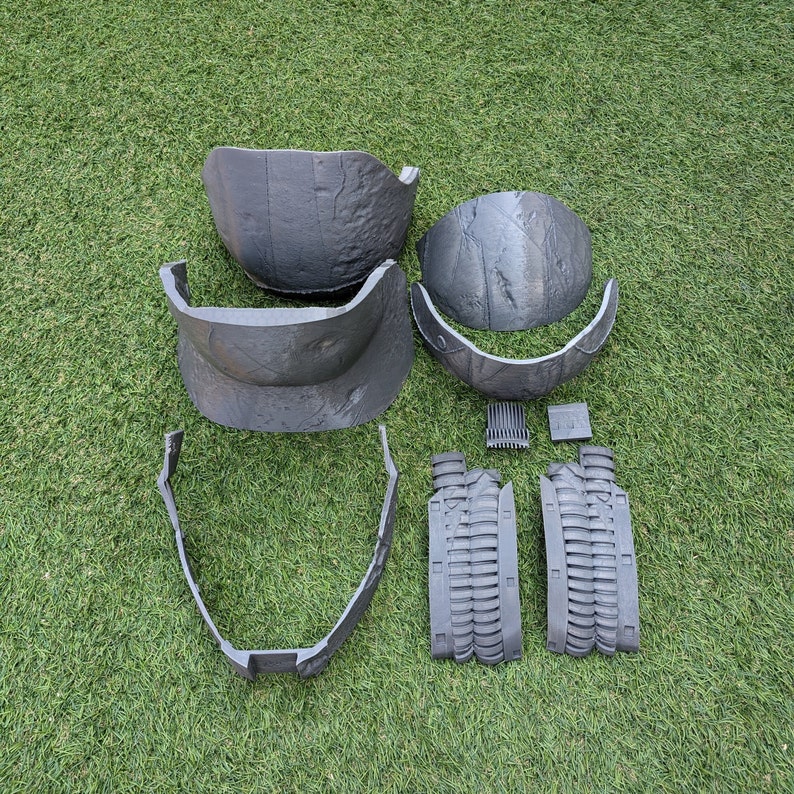 May include: A set of six gray plastic helmet pieces for cosplay or costume making. The pieces include a top, front, back, and two side pieces.