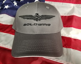 May include: A gray baseball cap with a black embroidered eagle and the text "GOLD WING".