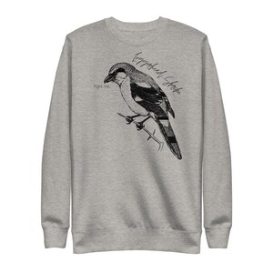 May include: A gray sweatshirt with a black and white illustration of a bird with the text "Loggerhead Shrike" and "Fight me" printed on it.