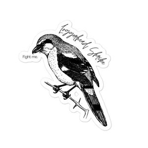 May include: Black and white illustration of a Loggerhead Shrike perched on a branch. The text "Fight me." is below the bird and "Loggerhead Shrike" is above the bird.