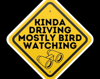 May include: Yellow diamond-shaped road sign with black text that reads "Kinda Driving Mostly Bird Watching" and a black and white illustration of binoculars.