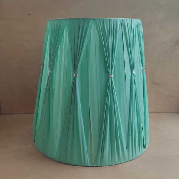 Vintage large Soviet pleated lampshade made of light green plastic ribbons on a metal frame, lampshade in retro style.