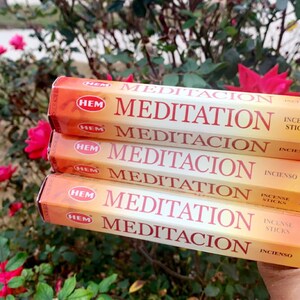 May include: Five packs of HEM Meditation incense sticks. The packaging is orange and white with the text "HEM Meditation" and "Incienso" printed on it.