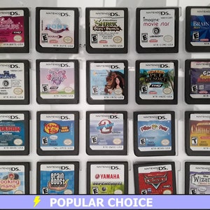 May include: A collection of 20 Nintendo DS game cartridges displayed in a clear plastic case. The cartridges are arranged in four rows of five. The cartridges are all different colors and have different titles, including "Brain Age", "Cooking Mama", "Shrek", "Pony", and "Wizards".