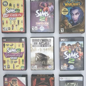 Puede incluir: Una colección de cajas de juegos de video, incluyendo Los Sims 2, World of Warcraft, Brothers in Arms: Earned in Blood, Fable: The Lost Chapters, Diablo II y Fallout 3. Las cajas son todas negras y presentan varios títulos y logotipos de juegos.