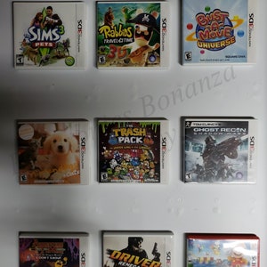 May include: Nine Nintendo 3DS game cartridges, including The Sims 3 Pets, Rabbids Travel in Time 3D, Bust-A-Move Universe, Nintendogs + Cats, The Trash Pack, Ghost Recon Shadow Wars, Adventure Time:  I Don't Know, Driver Renegade, and Super Mario Maker.