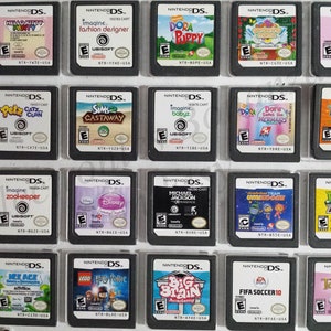 May include: A collection of Nintendo DS game cartridges, featuring titles like "Hello Kitty Party," "Sims Castaway," and "Plants vs. Zombies." The cartridges are black with colorful game art and text labels.