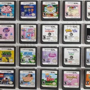 May include: A collection of 20 Nintendo DS game cartridges, displayed in a grid on a white background. The cartridges are arranged in rows of four, with each cartridge featuring a different game title and cover art. Some of the games include "Big Brain Academy", "Dora Saves the Mermaids", "Plants vs. Zombies", "Lego Harry Potter", and "Cooking Mama".
