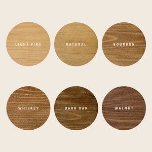May include: Six wood stain color samples in round circles. The colors are light pine, natural, bourbon, whiskey, dark oak, and walnut.
