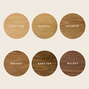 May include: Six wood stain color samples in round circles. The colors are light pine, natural, bourbon, whiskey, dark oak, and walnut.