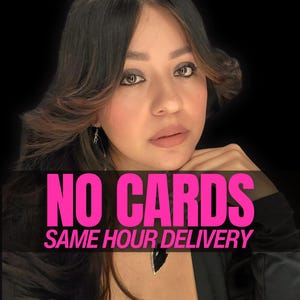 May include: A person with dark brown hair and brown eyes wearing a black arrowhead pendant necklace. The image features bold pink text overlay that reads NO CARDS SAME HOUR DELIVERY against a solid black background, highlighting the jewelry piece.