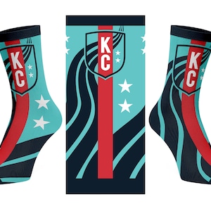 May include: A pair of blue and black socks with a red stripe and a white star pattern. The socks feature a logo with the letters "K C" in a shield shape.