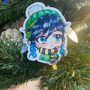 May include: A cartoon character with blue hair and green eyes wearing a green and white hat with a white pom-pom. The character is wearing a yellow and blue scarf and a green sweater.