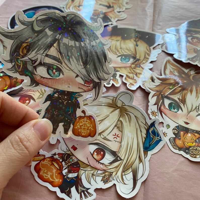 May include: A set of five Halloween-themed stickers featuring anime-style characters holding pumpkins. The stickers are printed on white paper with a glossy finish.
