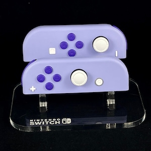 Conjunto Nintendo Joy-Con violeta con ABXY morado y detalles en blanco