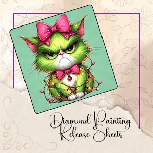 May include: A diamond painting release sheet featuring a grumpy green cat with a pink bow and a pink bow tie. The cat is wrapped in a string of Christmas lights. The text "Diamond Painting Release Sheets" is written in cursive.