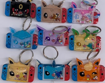 anime poke switch eeveelution shaker keychains, eevee, umbreon, leafeon, sylveon, glaceon, espeon, vaporeon, jolteon, flareon