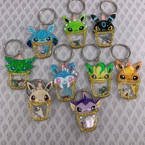shiny poke shaker cup anime keychains, eevee, eeveelutions, vaporeon, jolteon, flareon, espeon, glaceon, sylveon, leafeon