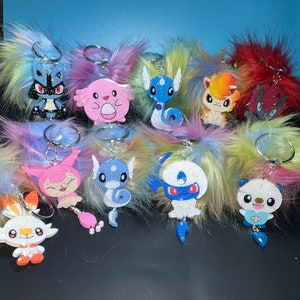 anime poke keychains pom pom phone charm scorbunny oshawott skitty chancy lucario ponyta absol dratini  zoroark dragonair