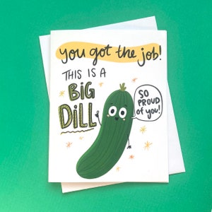 May include: A white card with a green cartoon pickle and the text "you got the job! This is a big dill. So proud of you!"