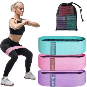 May include: Three fabric resistance bands in turquoise, pink, and purple colors. The bands are stacked on top of each other and have the word "SPIRITO" printed on them. The bands are in a mesh bag.