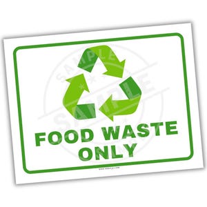 May include: A white rectangular sign with a green border and the words "FOOD WASTE ONLY" in green. A green recycling symbol is in the center. The sign is for food waste disposal.